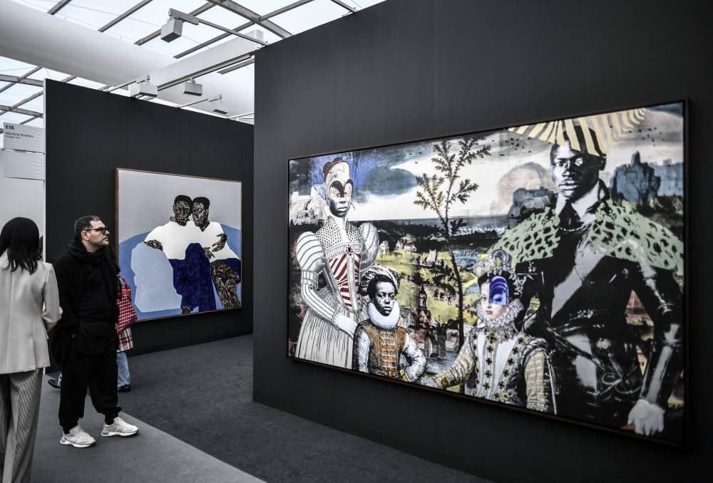 Visitors look at a painting by Raphael Barontini ‘A la cour d’Henri Christophe’ (2022) during the ‘Paris Art Basel’ event, ahead of the official opening of Europe’s biggest contemporary art market in Paris, on October 19, 2022. — AFP pic