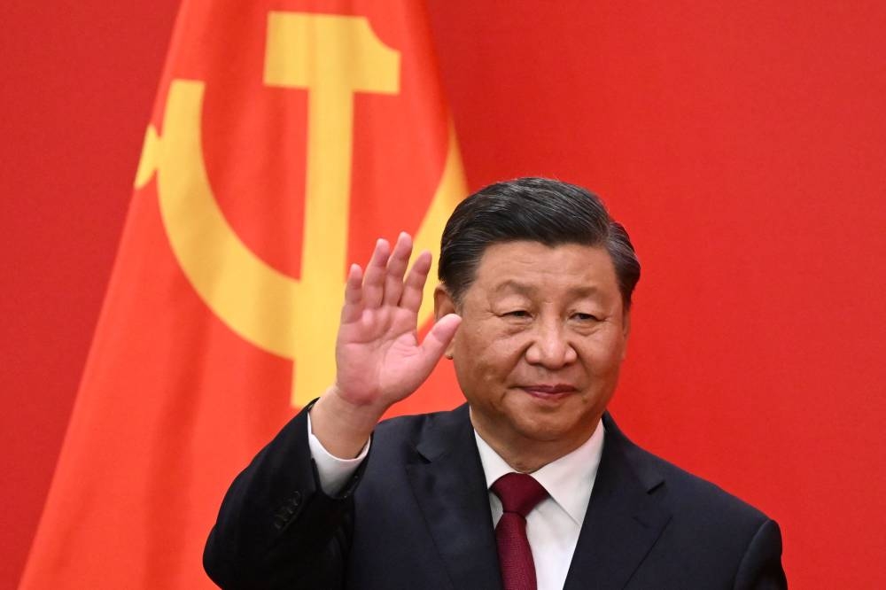 China's President Xi Jinping waves during the introduction of members of the Chinese Communist Party's new Politburo Standing Committee, the nation's top decision-making body, to the media in the Great Hall of the People in Beijing on October 23, 2022. — AFP pic