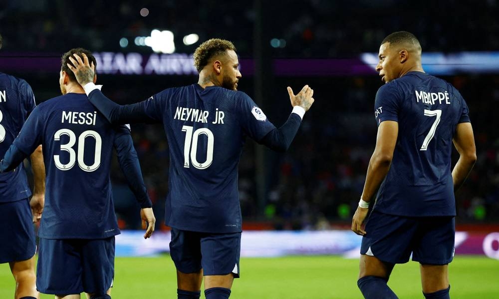 Paris St Germain's Neymar celebrates scoring their first goal against Olympique de Marseille with Kylian Mbappe and Lionel Messi at Parc des Princes, Paris October 16, 2022. — Reuters pic 