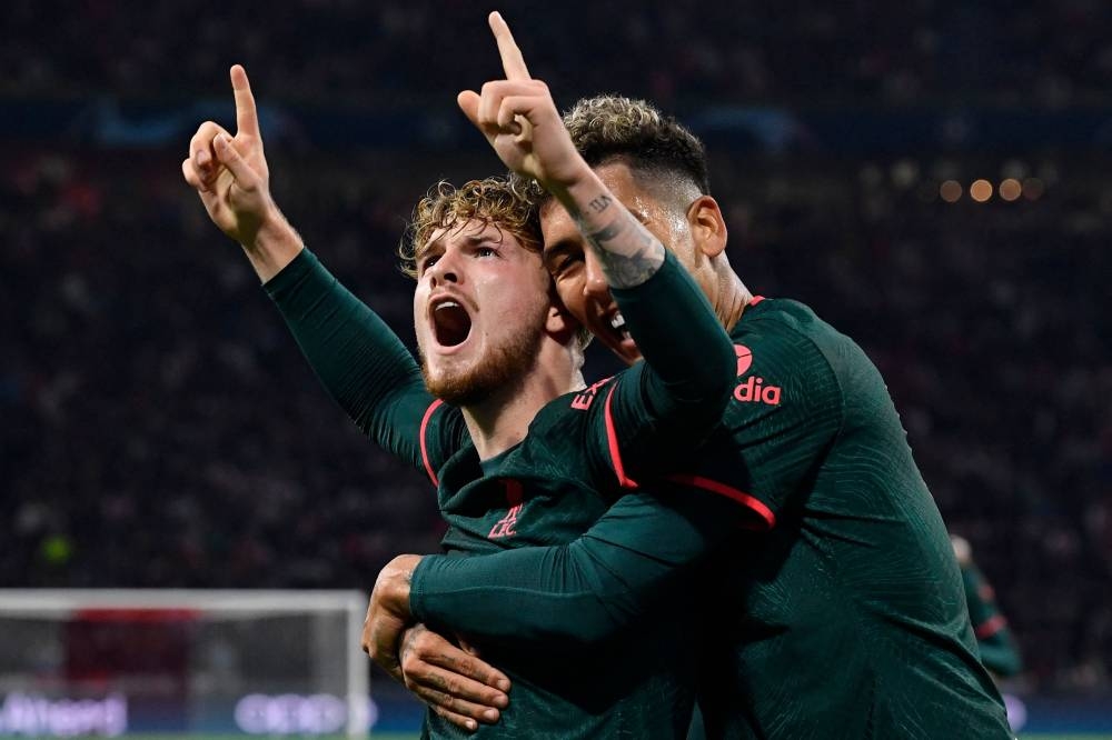 Liverpool midfielder Harvey Elliott celebrates scoring his team's third goal with striker Roberto Firmino during the match against Ajax Amsterdamat the Johan Cruyff Arena in Amsterdam October 26, 2022. — AFP pic