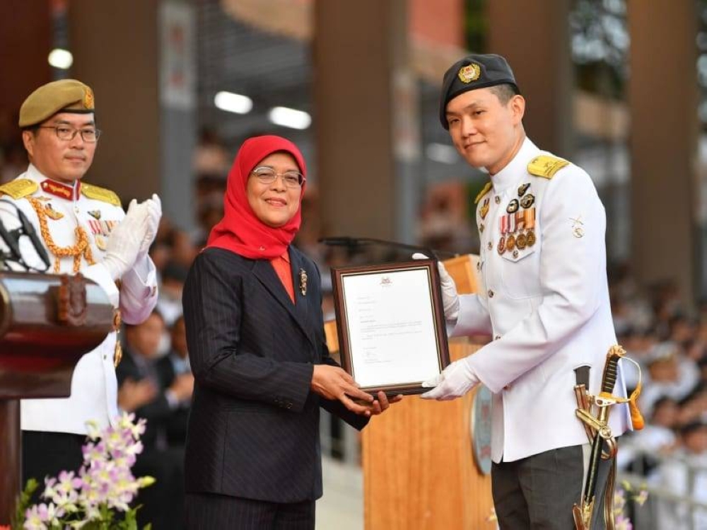 Brigadier-General Lee Yi-Jin (right) being presented the letter of appointment as the Chief of the Digital and Intelligence Service by President Halimah Yacob (centre). ― Picture courtesy of Ministry of Defence 