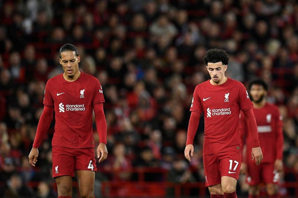 Liverpool's defender Virgil van Dijk and midfielder Curtis Jones look on after Leeds United score their second goal during the English Premier League football match between Liverpool and Leeds United at Anfield in Liverpool on October 29, 2022.— AFP pic