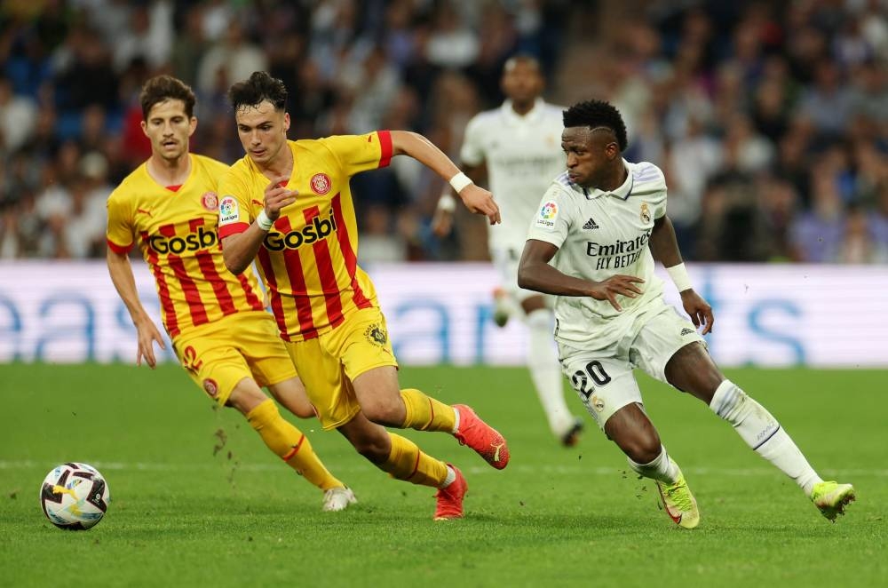 Girona's Arnau Martinez in action with Real Madrid's Vinicius Junior at the Santiago Bernabeu, Madrid October 30, 2022. — Reuters pic