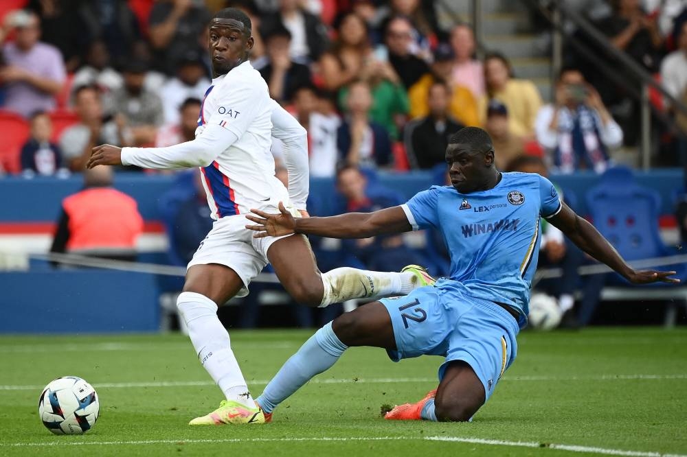 Paris Saint-Germain’s French defender Presnel Kimpembe (left) fights for the ball with Troyes’ Portuguese defender Abdu Conte at The Parc des Princes Stadium in Paris, October 29, 2022. — AFP pic