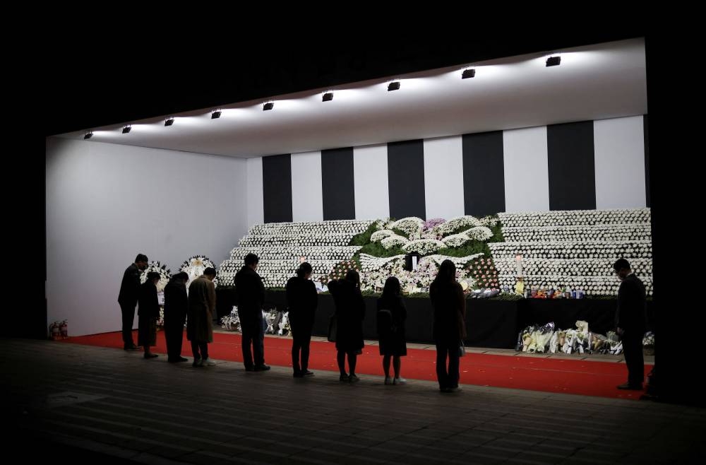 People mourn at a group memorial for the victims of the crowd crush that happened during Halloween festivities, at Seoul City Hall Plaza in Seoul, South Korea, November 3, 2022. — Reuters pic