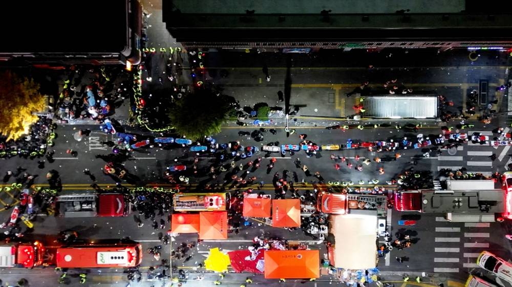 Rescue workers work at the scene where a stampede during Halloween festivities killed and injured many people at the popular Itaewon district in Seoul, South Korea, October 30, 2022. — Yonhap pic via Reuters