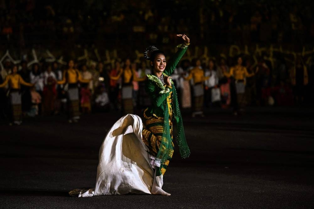 This photo taken on November 6, 2022 shows a dancer performing during the Tazaungdaing Lighting Festival at Pyin Oo Lwin Township in Mandalay. — AFP pic