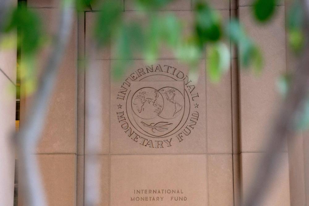 The International Monetary Fund (IMF) logo is displayed outside its headquarters in Washington, DC, on October 8, 2022. — AFP pic