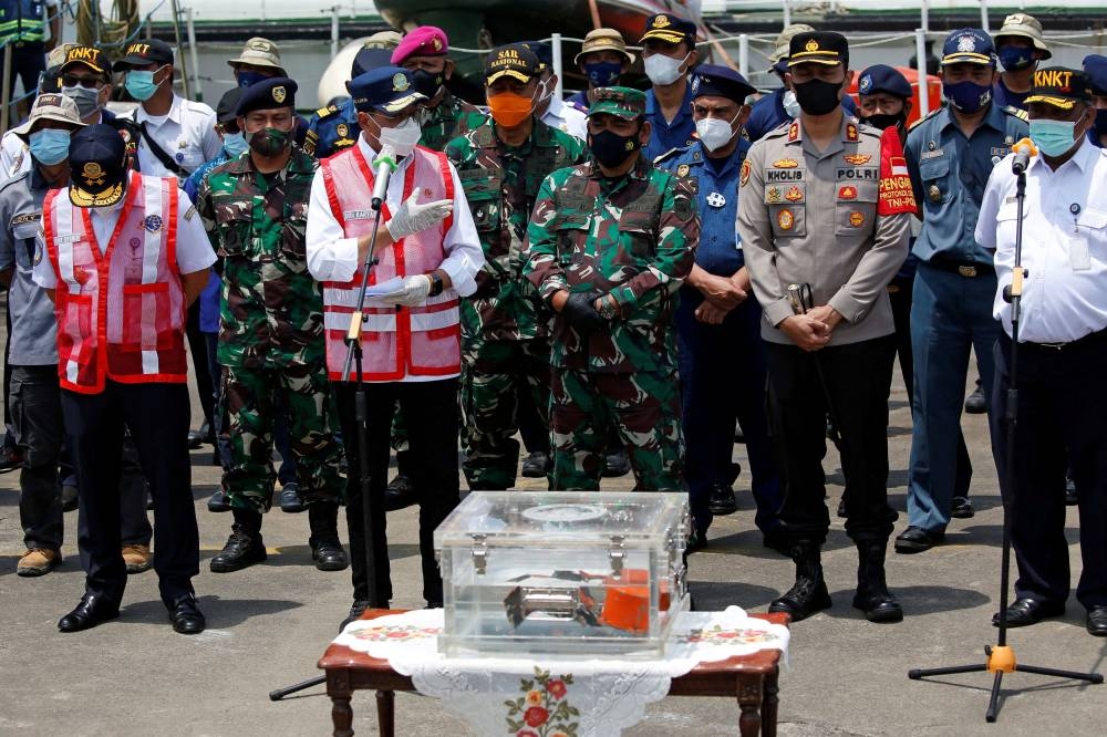 Indonesia's Transport Minister Budi Karya Sumadi speaks to the media as the Cockpit Voice Recorder (CVR) of Sriwijaya Air flight SJ 182 is displayed at Tanjung Priok Port in Jakarta, Indonesia, March 31, 2021. — Reuters pic