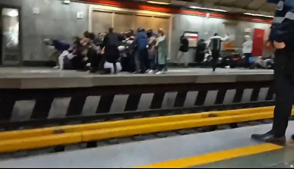 This grab taken from a UGC video made available on the ESN platform on November 16, 2022, reportedly shows Iranians at a metro station in Tehran fleeing and falling down as gunshots are heard. — Pic by various sources/AFP