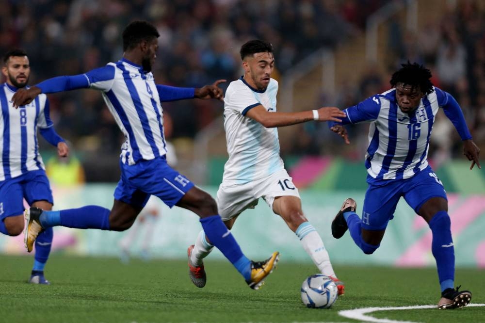 In this file photo taken on August 10, 2019, Argentina’s Nicolas Gonzalez (C) battles for the ball with Honduras’ players Elison David Rivas Mejia (L) and Jose Antonio Garcia Robledo (R) during the Men's Football Gold Medal Match between Argentina and Honduras at the Lima 2019 Pan-American Games in Lima. — AFP pic