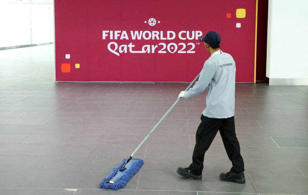 A worker cleans the floor at the main media center Qatar National Convention Center ahead of Fifa 2022 World Cup, in Doha, Qatar November 3, 2022. — Reuters pic