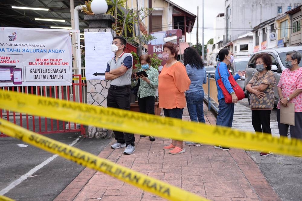 Voters queue up to cast their ballots in George Town, Penang November 19, 2022. ― Picture by Steven KE Ooi