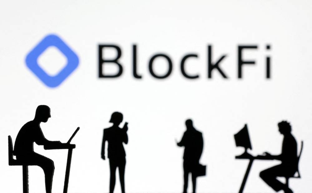 Figurines with smartphones and computers are seen in front of the BlockFi logo in this illustration, November 28, 2022. ― Reuters pic