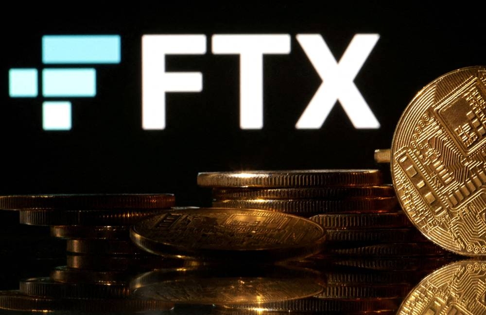 Representations of cryptocurrencies are seen in front of displayed FTX logo in this illustration taken November 10, 2022. — Reuters pic