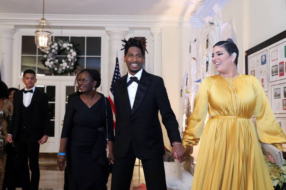 Musician Jon Batiste arrives with his wife Suleika Jaouad alongside family members for a state Dinner in honor of French President Emmanuel Macron at the White House in Washington December 1, 2022. — Reuters pic