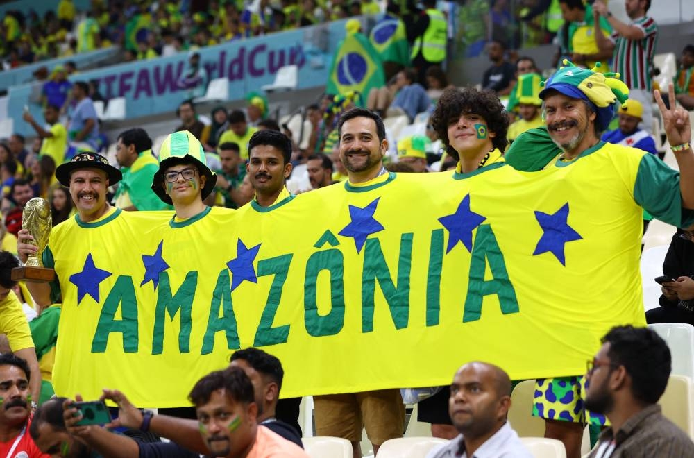 Brazil fans pose wearing a shirt that reads ‘AMAZONIA’ during the World Cup Qatar 2022 Group G match between Cameroon and Brazil at the Lusail Stadium in Lusail, Qatar, December 2, 2022