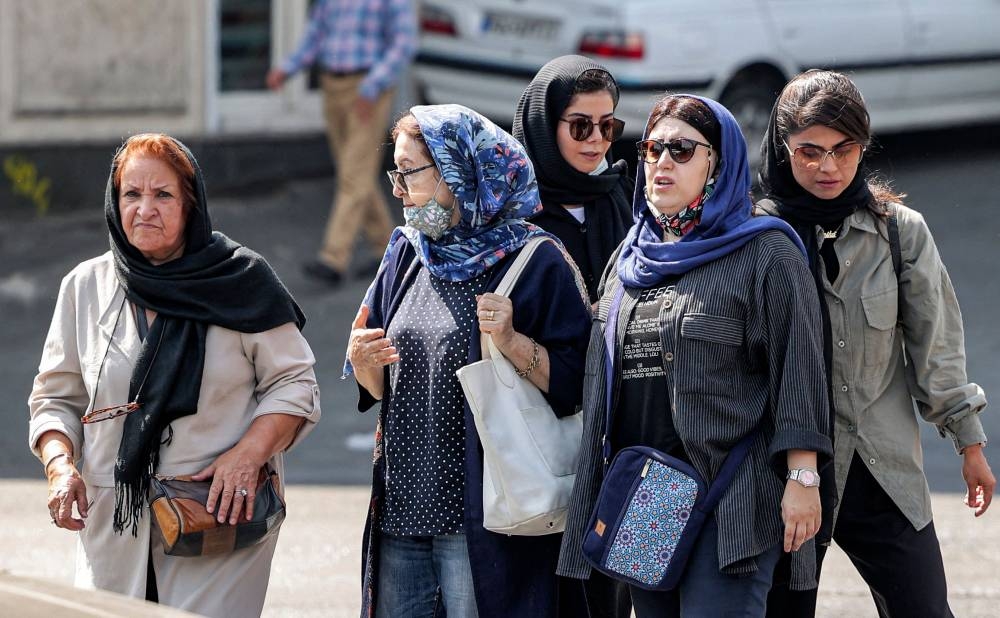 In this file photo taken on September 26, 2022, women walk along a street in the centre of Iran's capital Tehran. — AFP pic