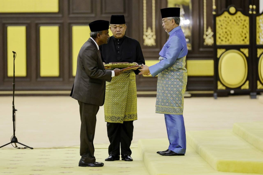 The Yang di-Pertuan Agong Al-Sultan Abdullah Ri'ayatuddin Al-Mustafa Billah Shah bestowing the document of appointment as Minister of Human Resources to VN Sivakumar at Istana Negara December 3, 2022. — Bernama pic