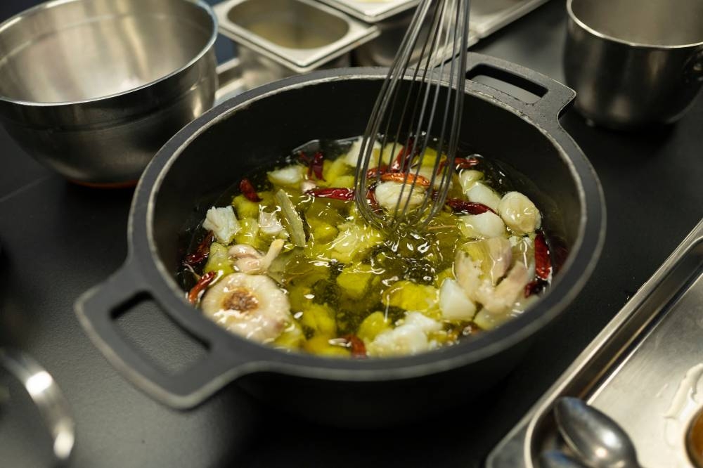 This photograph taken on December 1, 2022 shows a meal getting prepared by the Spanish twin chefs, Javier and Sergio Torres in the kitchen of their restaurant 'Cocina Hermanos Torres' after receiving the distinction of three-stars from the Michelin guide, in Barcelona. — AFP pic