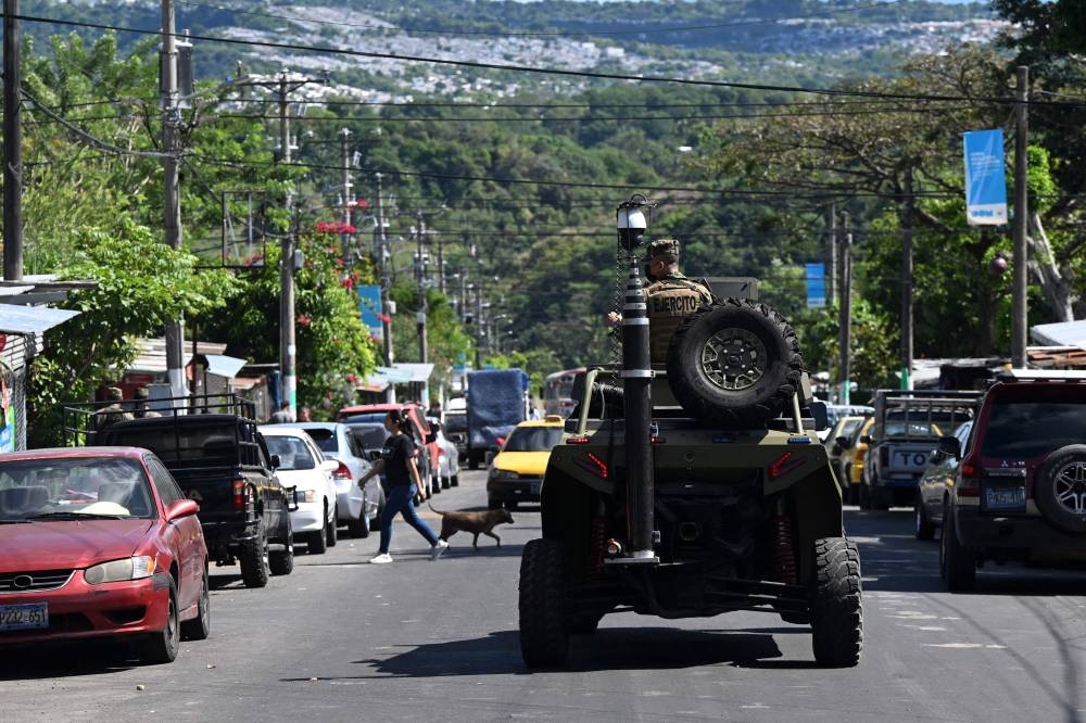 A Salvadorean Army armored vehicle patrols during an operation against gang members in La Campanera, a community historically controlled by the 18th street gang, in Soyapango, El Salvador, on December 4, 2022. — AFP pic