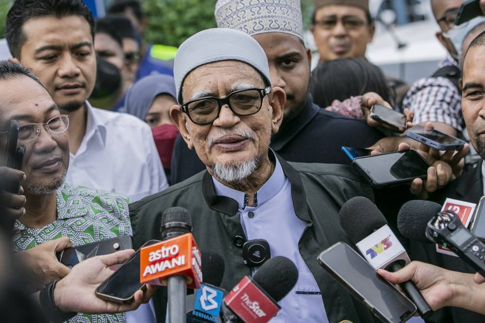 PAS president Tan Sri Abdul Hadi Awang speaks to the media after giving a police statement at IPD Sentul, Kuala Lumpur, December 5, 2022. — Picture by Hari Anggara