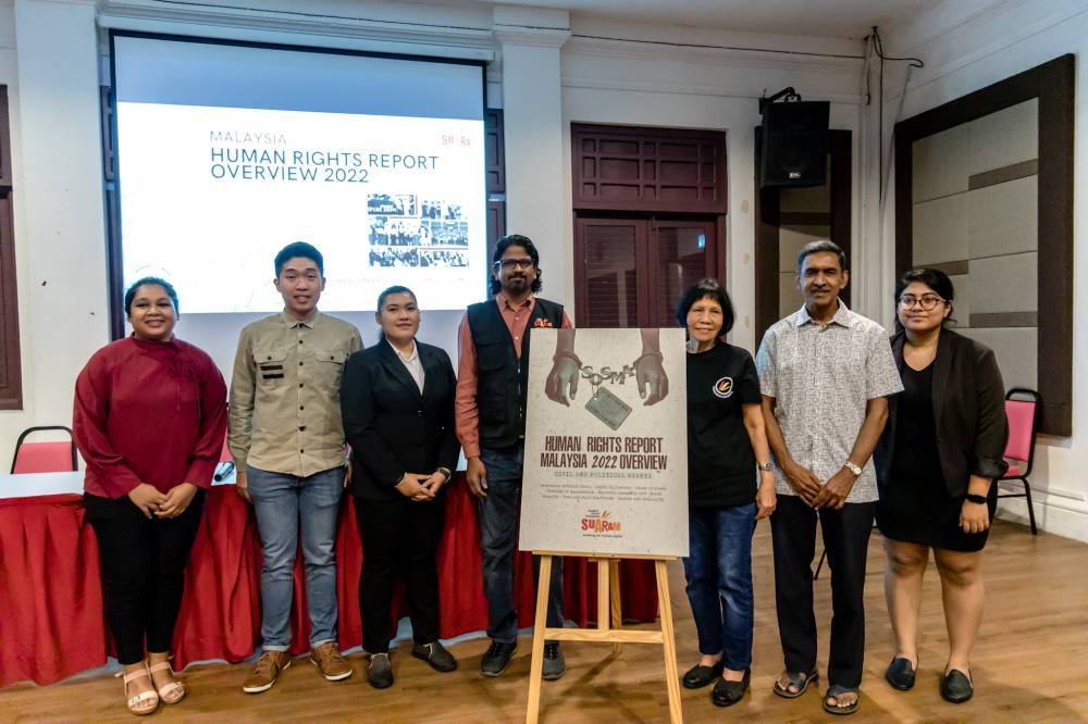 Suaram members pose for a group photo during launch of its Human Rights Report at the Kuala Lumpur and Selangor Chinese Assembly Hall on December 6, 2022. — Picture by Firdaus Latif