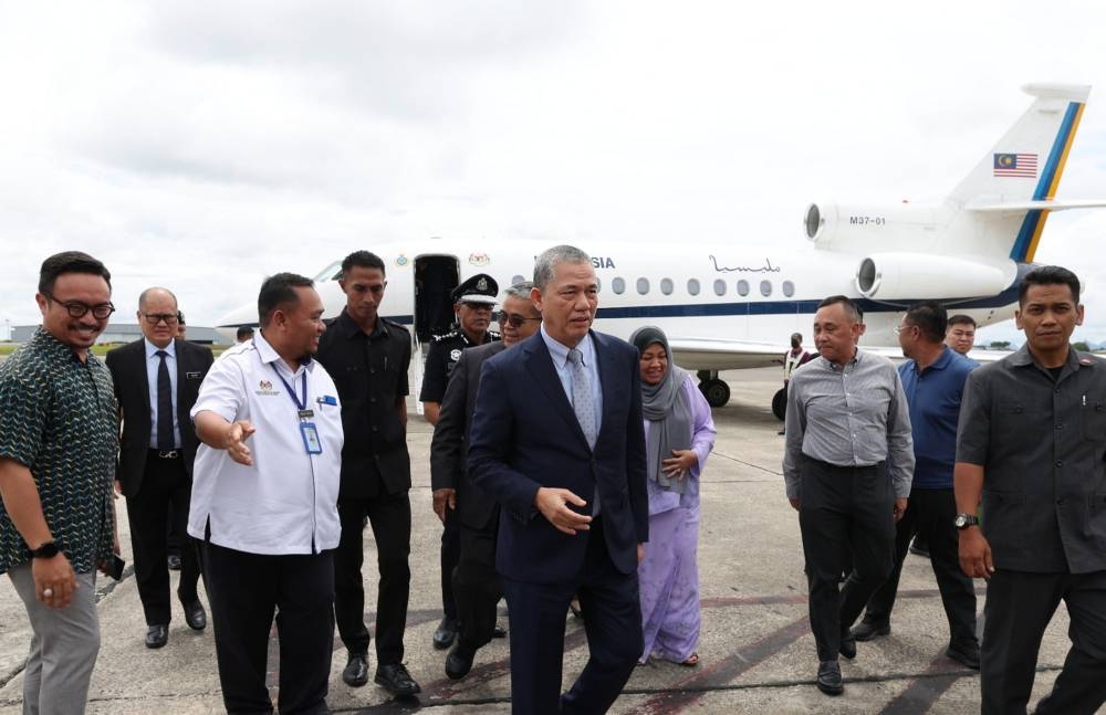 DPM II Datuk Seri Fadillah Yusof (centre) arrives at the Kuching International Airport December 8, 2022. ― Bernama pic