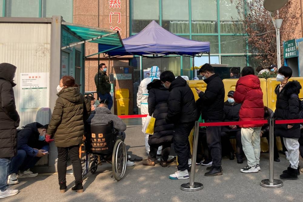 People line up at a fever clinic at The Central Hospital of Wuhan, after the government gradually loosened the coronavirus disease (COVID-19) restrictions, in Wuhan, Hubei province, China December 9, 2022. — Reuters pic