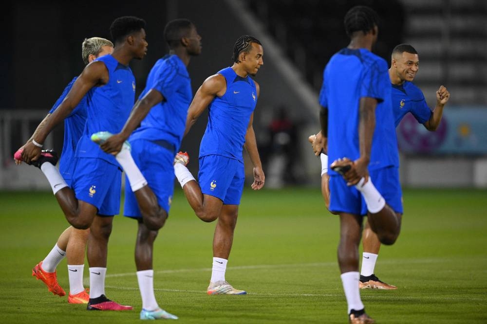 France’s forward #10 Kylian Mbappe (right) and his teammates take part in a training session at Al Sadd SC Stadium in Doha, on December 9, 2022, on the eve of the Qatar 2022 World Cup quarter-final football match between England and France. — AFP pic