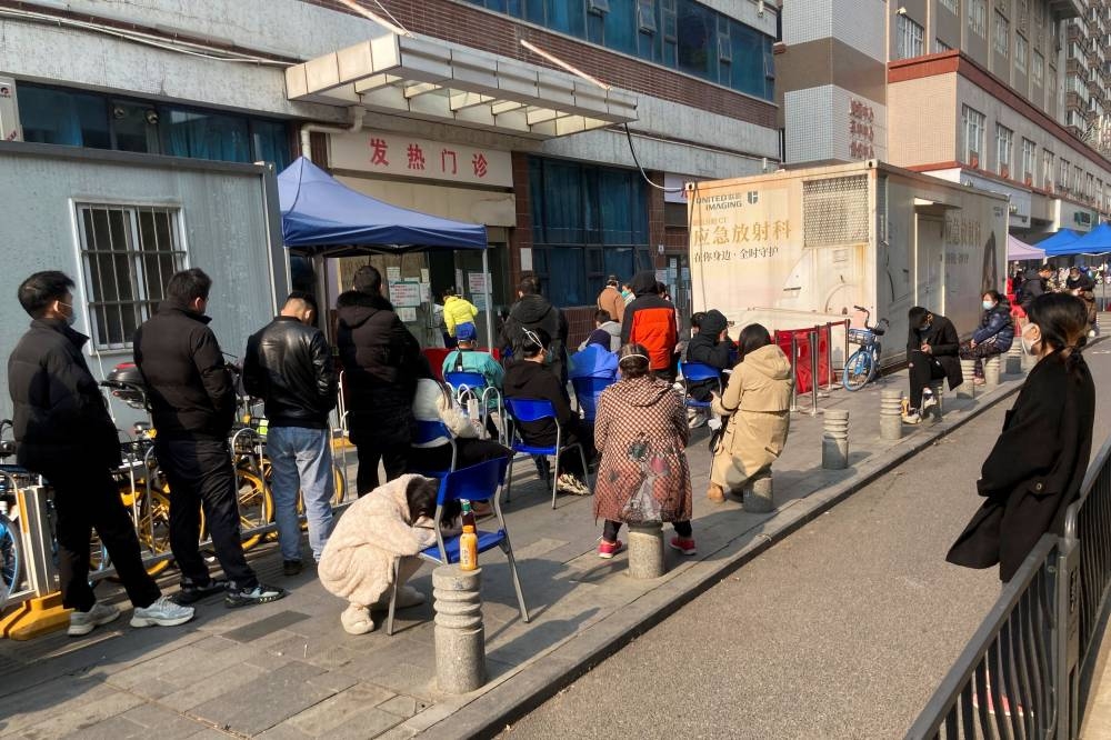 People line up at a fever clinic of a hospital, after the government gradually loosens the restrictions on the coronavirus disease (COVID-19) control, in Wuhan, Hubei province, China December 10, 2022. — Reuters pic