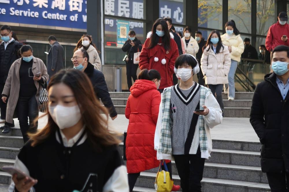 People walk out of a subway station during morning rush hour in Wuchang district, after the government gradually loosened restrictions on coronavirus disease (COVID-19) control, in Wuhan, Hubei province, China December 9, 2022. — Reuters pic