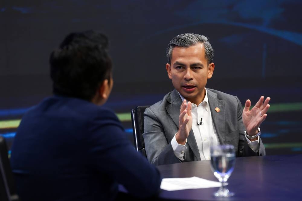 Communications Minister Fahmi Fadzi speaks during a programme on RTM News at Angkasapuri December 13, 2022. — Bernama pic