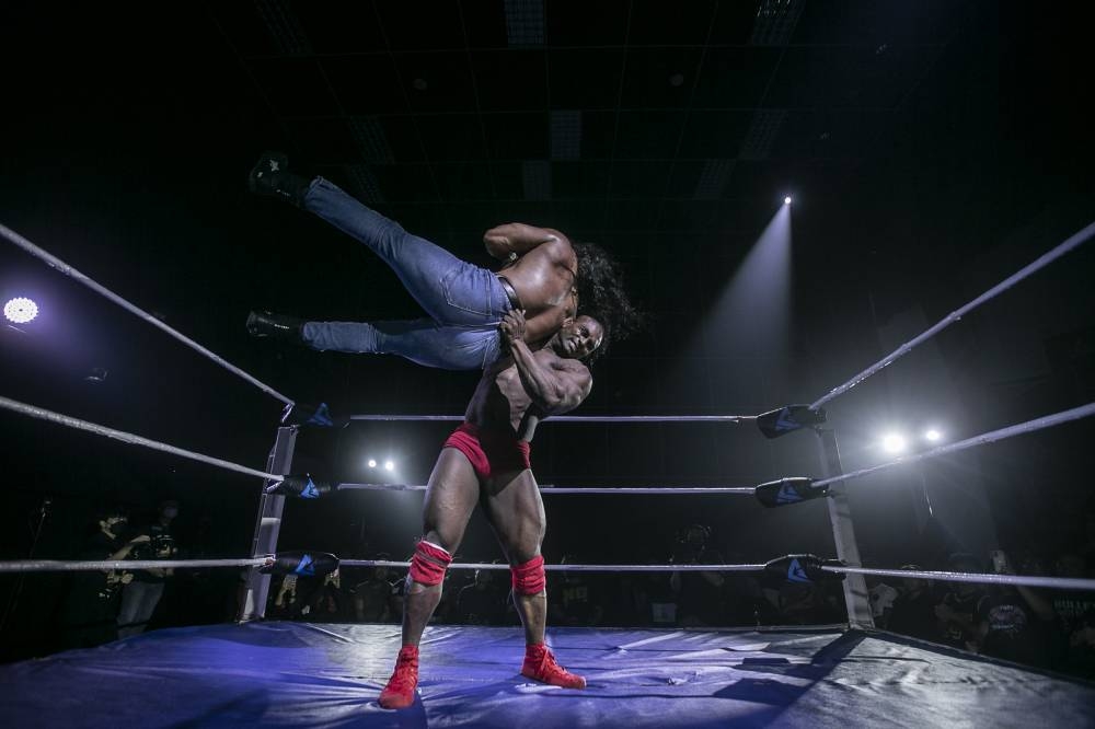 Malaysian wrestler Destroyer Dharma (red tights) taking on Azwan Serigala (jeans) in the day two showcase. — Picture by Hari Anggara.