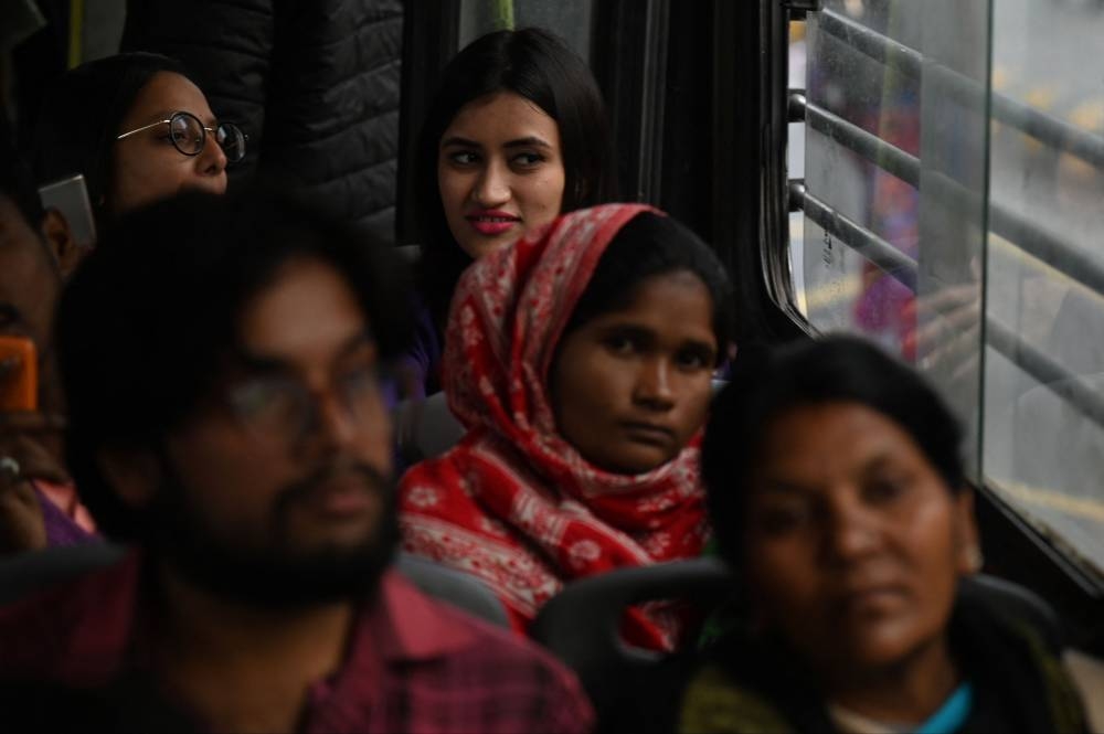 Women travel on a Delhi Transport Corporation bus in New Delhi December 8, 2022. — AFP pic