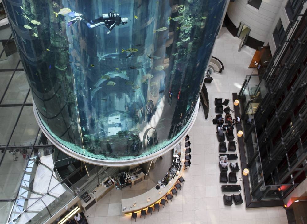 File photo shows divers cleaning the ‘AquaDom’ — a lobby aquarium in the Radisson Blu hotel — in central Berlin May 10, 2011. — Picture by DPA via AFP