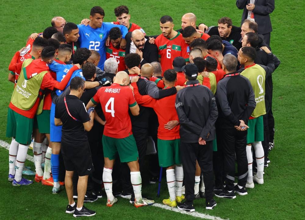 Morocco coach Walid Regragui talks with his players after the match against France at the Al Bayt Stadium in Al Khor, in Qatar, December 14, 2022. — Reuters pic