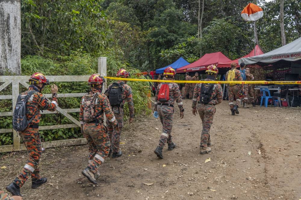 Rescue personnel working at the site of a landslide at the Father's Organic Farm campsite in Batang Kali, December 17, 2022. — Picture by Shafwan Zaidon