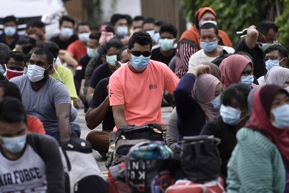 Undocumented immigrants are rounded up during a raid by the Immigration Department in Petaling Jaya May 20, 2020. — Picture by Miera Zulyana