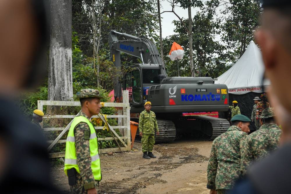 An Armed Forces excavator is used to dig the grounds of the Father's Organic Farm campsite during search and rescue operations in Batang Kali December 19, 2022. — Bernama pic