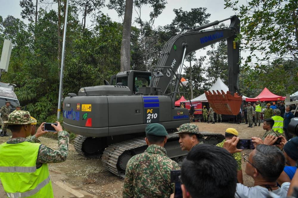 An Armed Forces excavator is used to dig the grounds of the Father's Organic Farm campsite during search and rescue operations in Batang Kali December 19, 2022. — Bernama pic