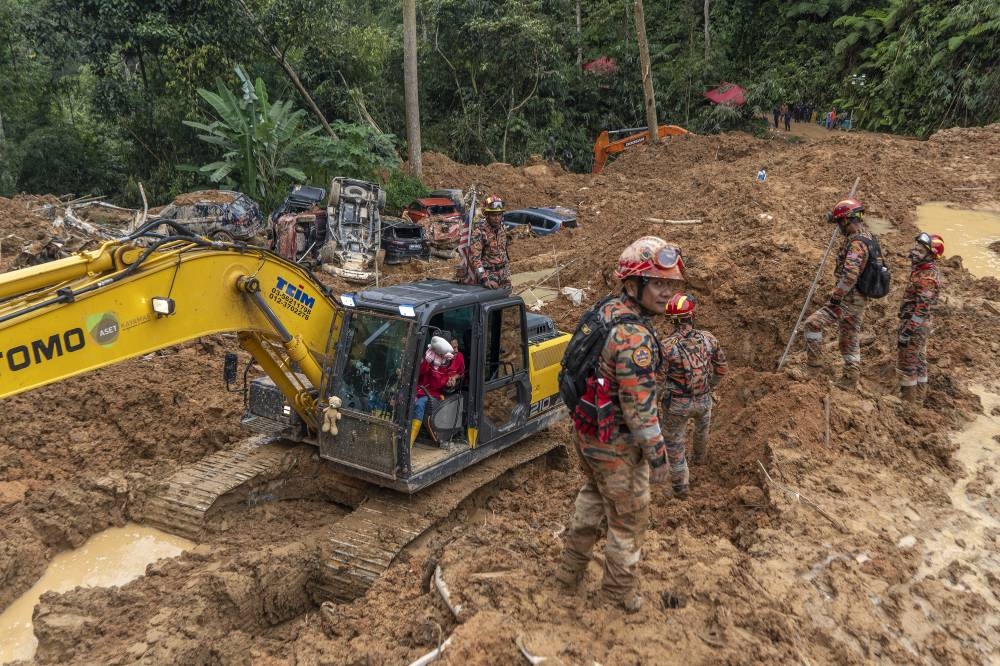 Rescue personnel work at the site of a landslide at the Father's Organic Farm campsite in Batang Kali, December 19, 2022. — Picture by Shafwan Zaidon