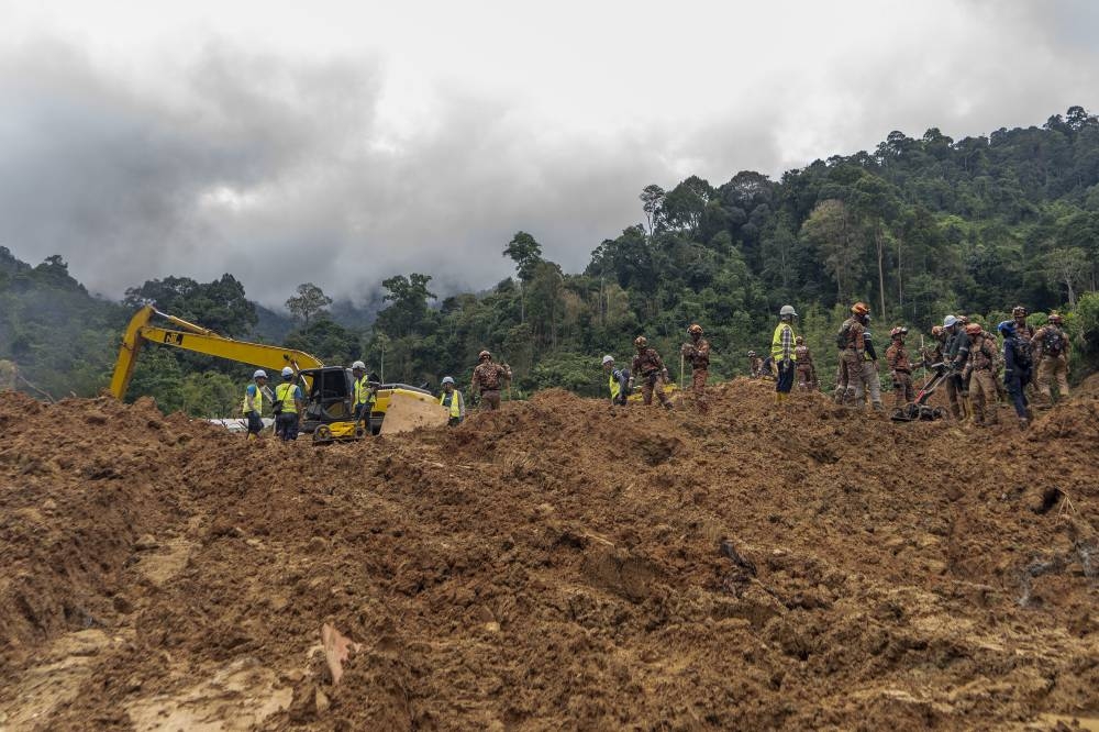 Rescue personnel work at the site of a landslide at the Father's Organic Farm campsite in Batang Kali, December 19, 2022. — Picture by Shafwan Zaidon