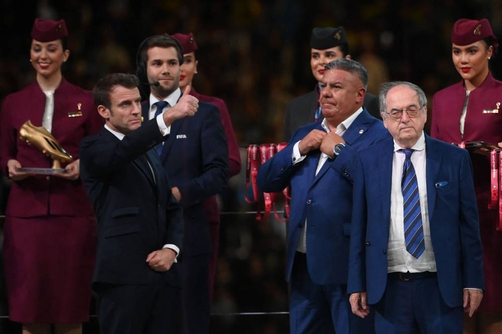 France's President Emmanuel Macron gestures beside French Football Federation (FFF) President Noel Le Graet (right) after the Qatar 2022 World Cup final football match between Argentina and France at Lusail Stadium in Lusail, north of Doha on December 18, 2022. — AFP pic