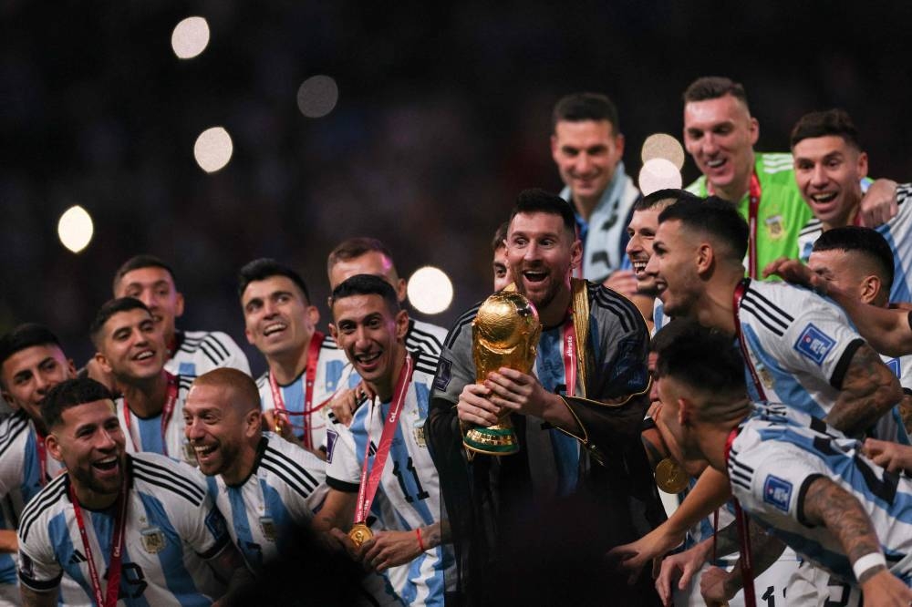 Argentina's captain and forward #10 Lionel Messi lifts the Fifa World Cup Trophy during the trophy ceremony after Argentina won the Qatar 2022 World Cup final football match between Argentina and France at Lusail Stadium in Lusail, north of Doha on December 18, 2022. — AFP pic