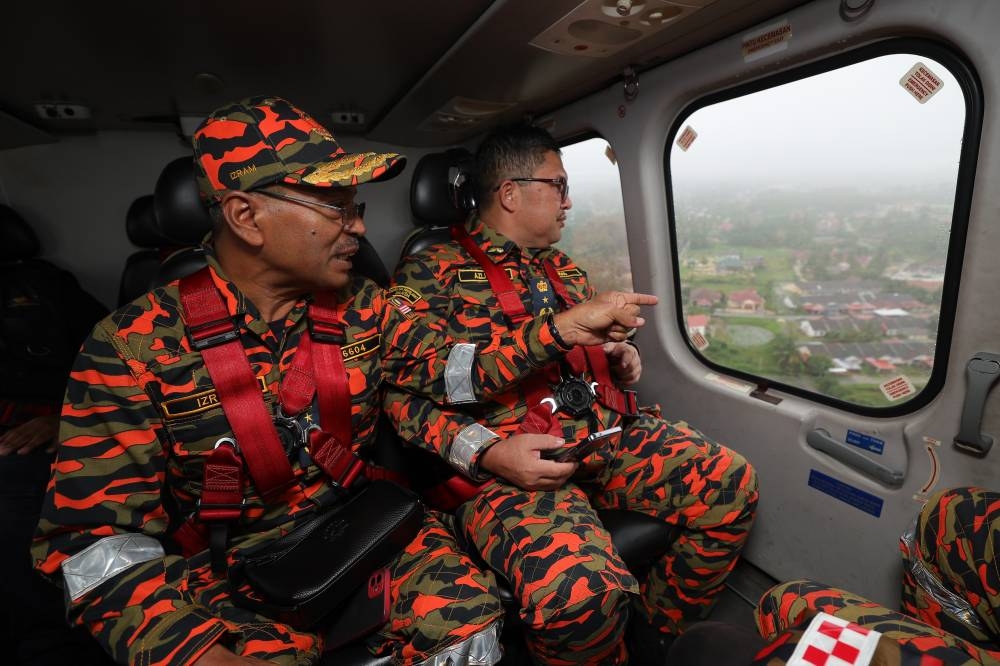 Fire and Rescue Department (JBPM) Fire Safety Division director Datuk Ahmad Izram Osman is seen during an aerial survey of the flood in Marang December 20, 2022. — Bernama pic