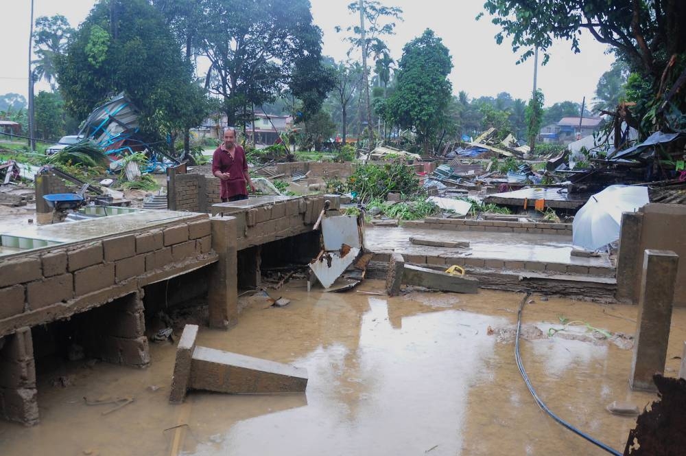 Flood victim Raja Kamaruddin Raja Muhamad stands next to the spot where his house used to be at Kampung La, Hulu Besut, Teregganu, December 20, 2022. — Bernama pic 