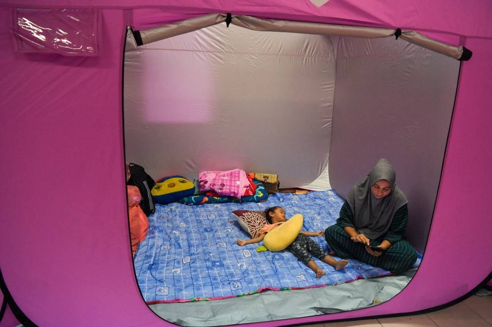 A child sleeps at the Sekolah Rendah Kuala Besut Satu flood relief centre in Besut, December 20, 2022. — Bernama pic