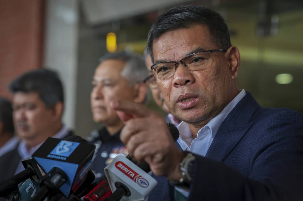 Datuk Seri Saifuddin Nasution Ismail speaks to reporters after launching a flood relief mission in Putrajaya December 21, 2022. — Bernama pic