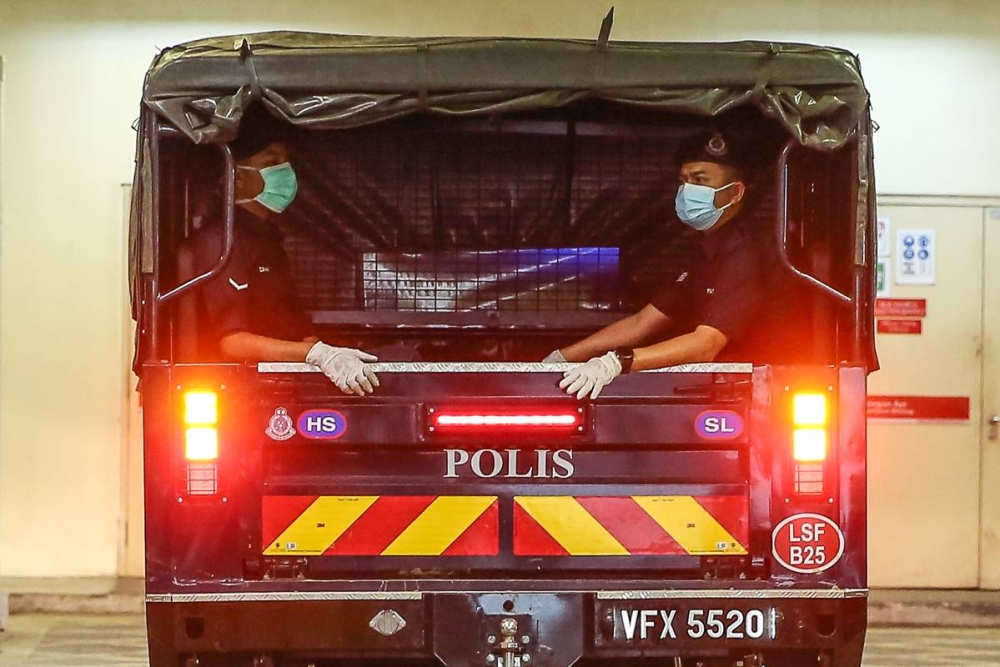 A police vehicle believed to be carrying bodies of the Batang Kali landslide victims arrives at the Sungai Buloh Hospital December 21, 2022. — Picture by Yusof Mat Isa